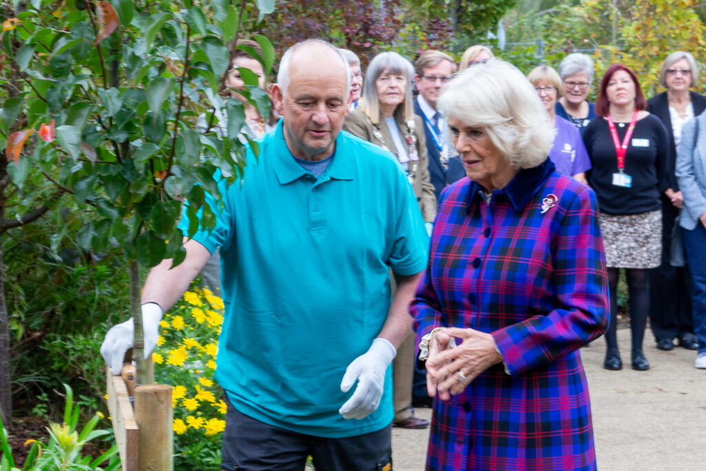 The Duchess of Cornwall with hospice gardener Kevin Loveland planting an ornamental pear tree at St Wilfrid’s Hospice