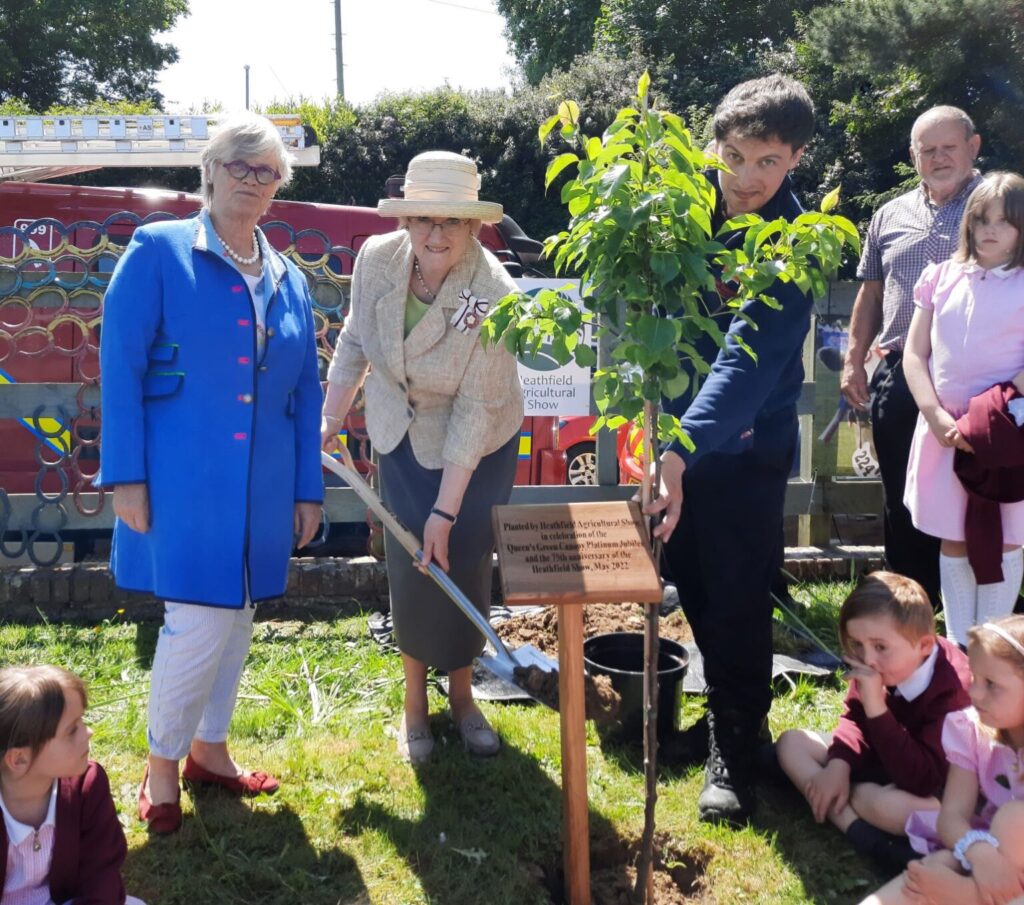 Show Secretary Nicola Magill with Mrs Sara Stonor planting the pear tree. Photo: The Heathfield News